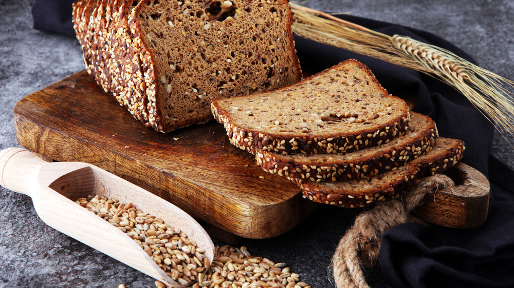 Whole grain bread next to a scoop of grains