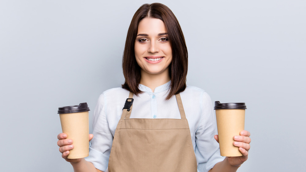 barista holding coffee cups