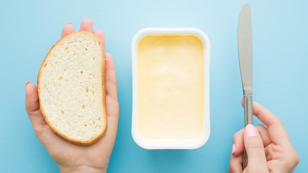bread, knife, tub of margarine
