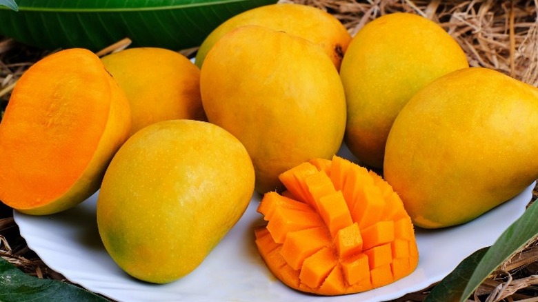 Mangoes on plate in grass