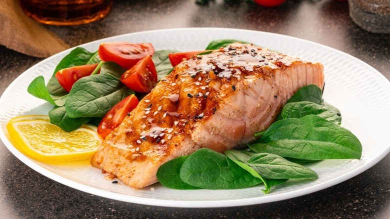 Salmon filet over salad greens