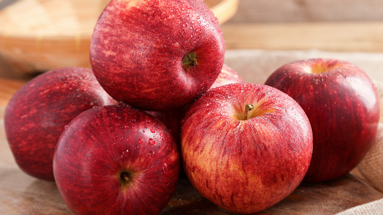 Wet apples on a wooden surface