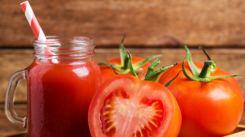 Tomatoes by tomato juice with straw