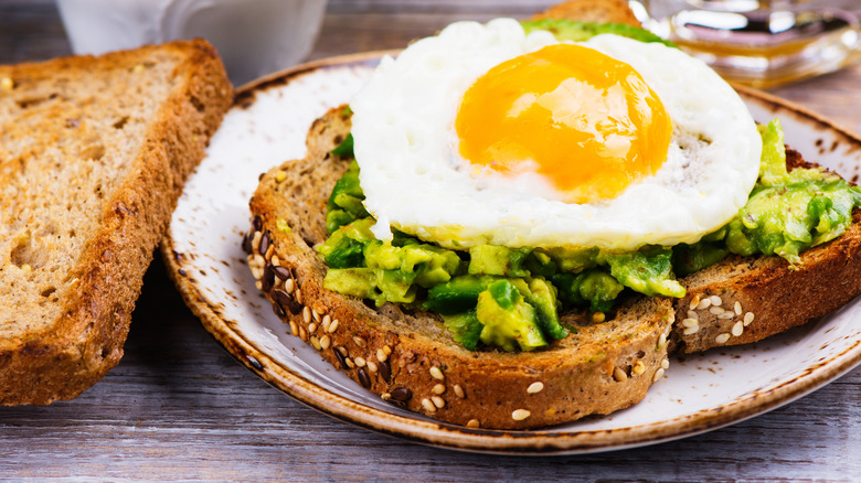 Fried egg atop avocado toast