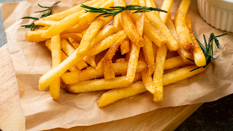 french fries served on wooden board