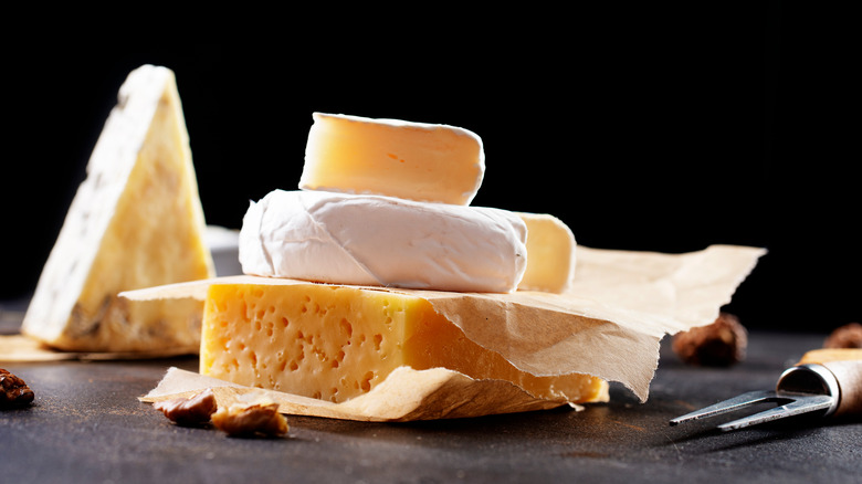 assorted cheeses served on table 