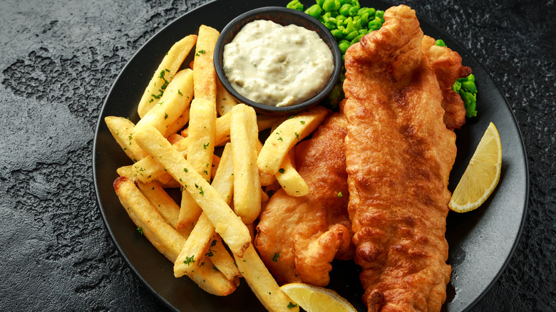fish and chips on black plate