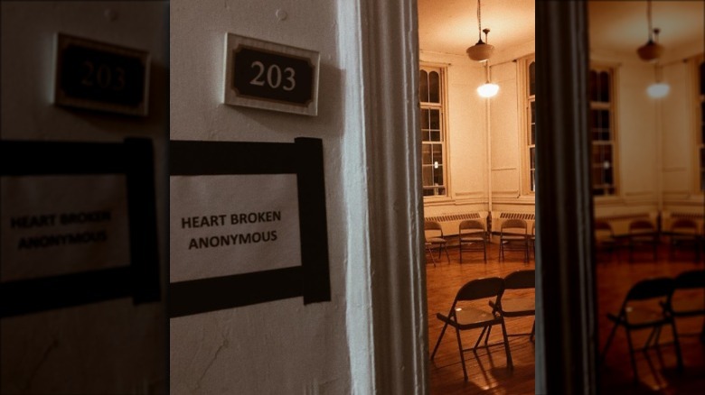 Open door looking in on a room filled with metal folding chairs, sign outside that says "Heart Broken Anonymous"