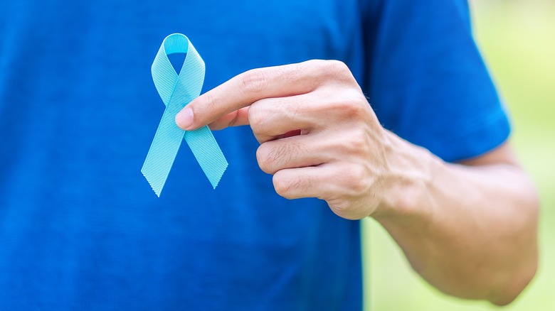 Man holding prostate cancer ribbon