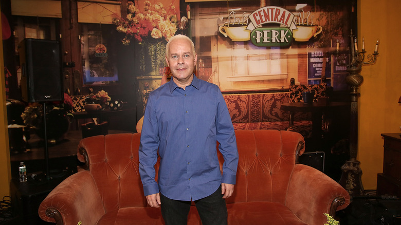 James Michael Tyler standing by couch in Central Perk