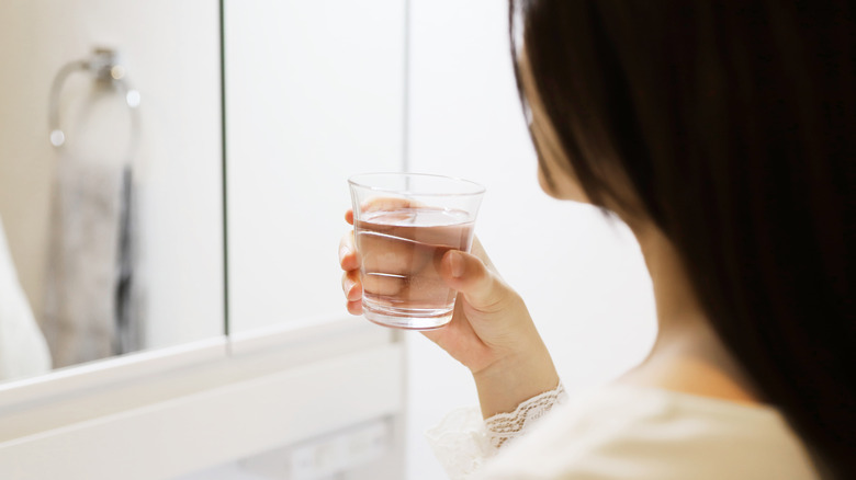 Woman gargling with salt water