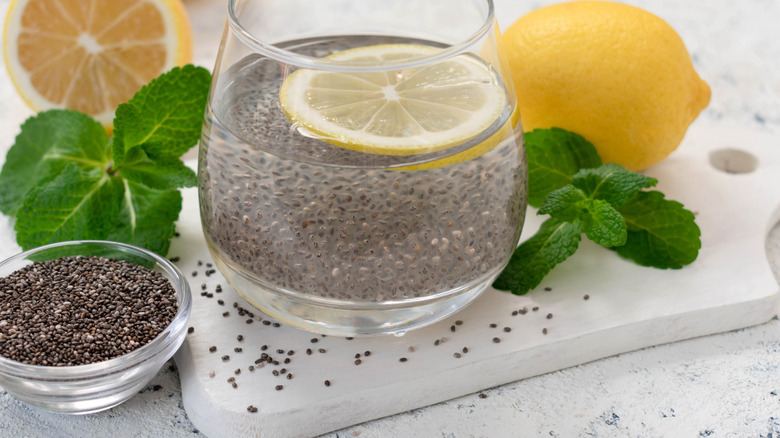 Dry chia with a glass of chia soaking in water
