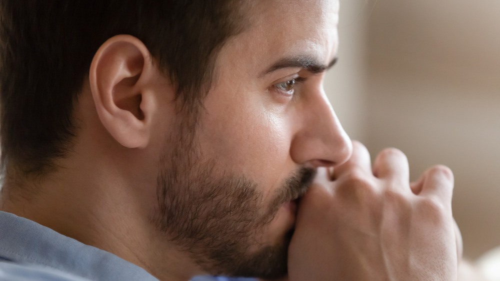 close up of a man looking sad 