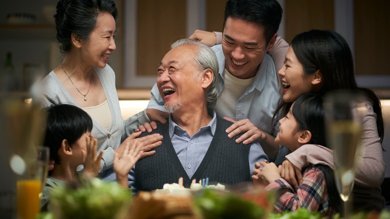 family laughing together at a dinner table