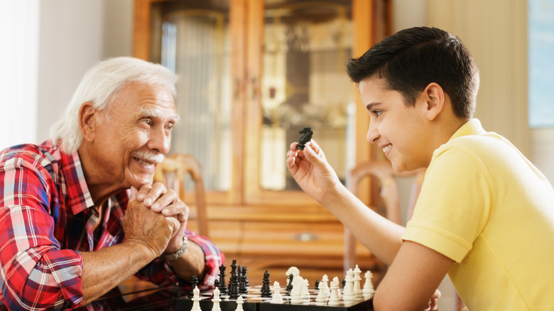 elderly man and boy playingi chess