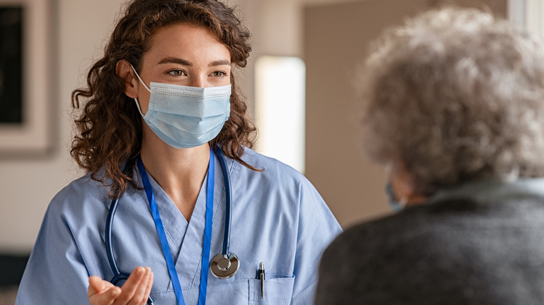 doctor with facemask giving consultation 