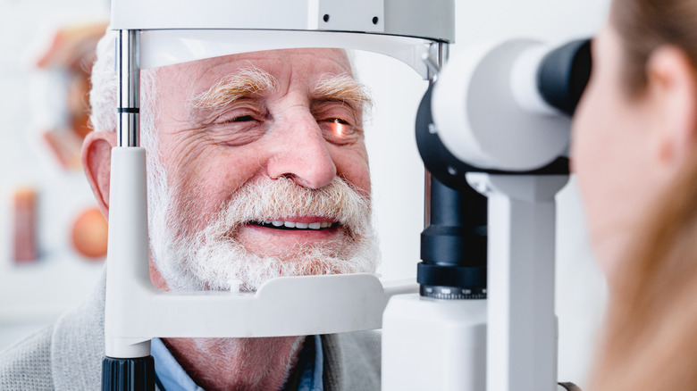 Elderly man undergoing an eye exam