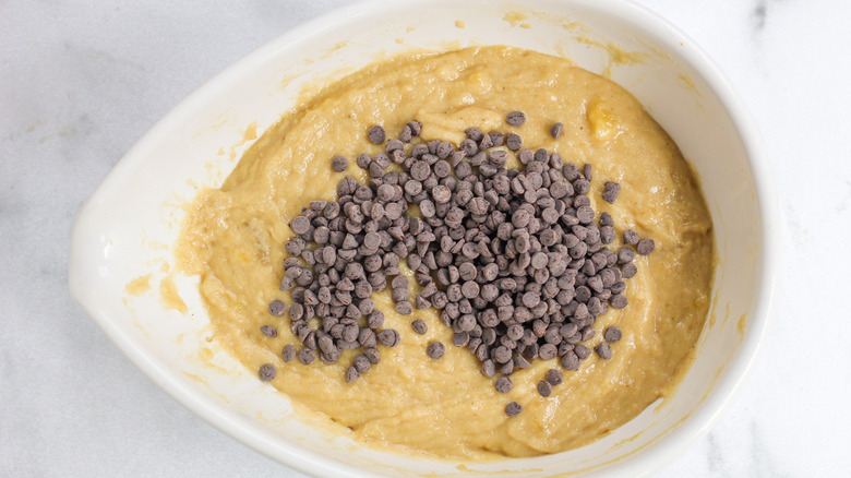 mini chocolate chips sitting on top of gluten-free chocolate chip banana loaf batter