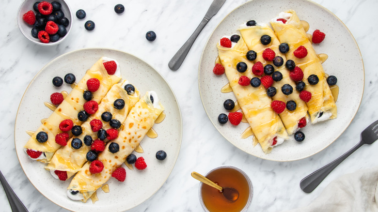 crepes and berries on plate 