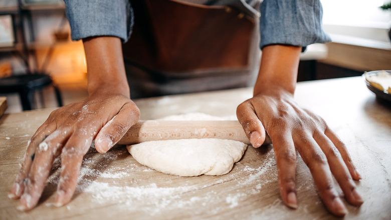 Woman making pizza dough