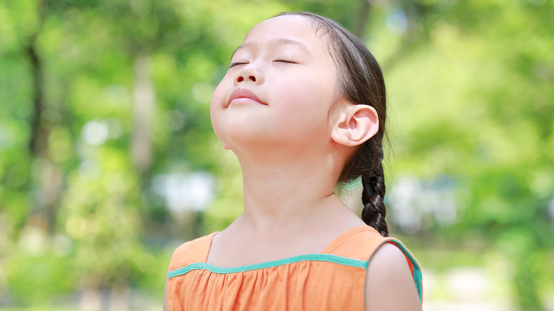 Child breathing in outdoor air