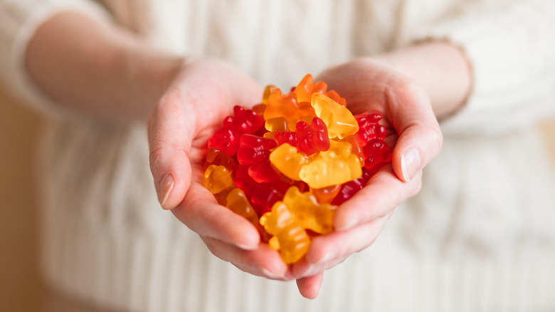 woman holding gummy vitamins