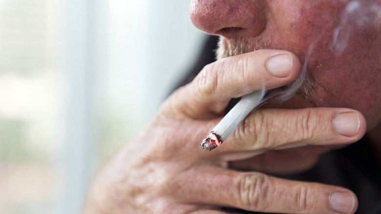 Close up of a man smoking a cigarette