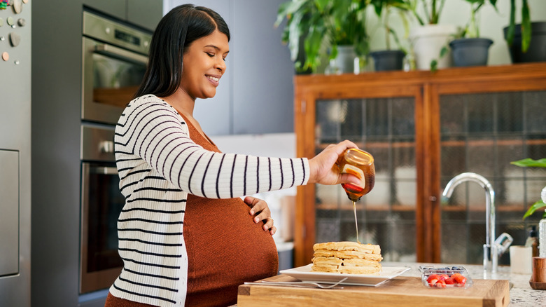 Pregnant woman making waffles