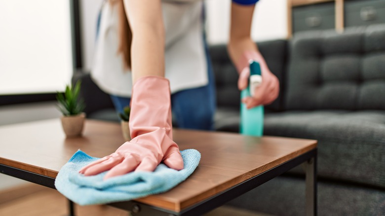 Woman cleaning table surface