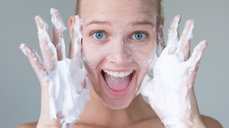 smiling woman with soapy hands