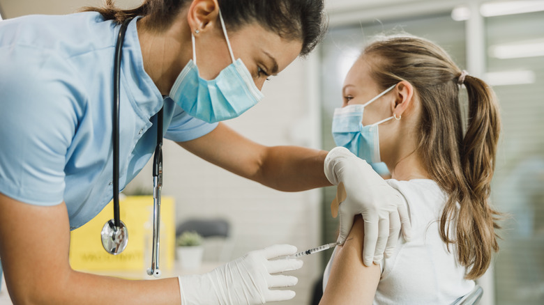 A girl gets vaccinated against COVID-19