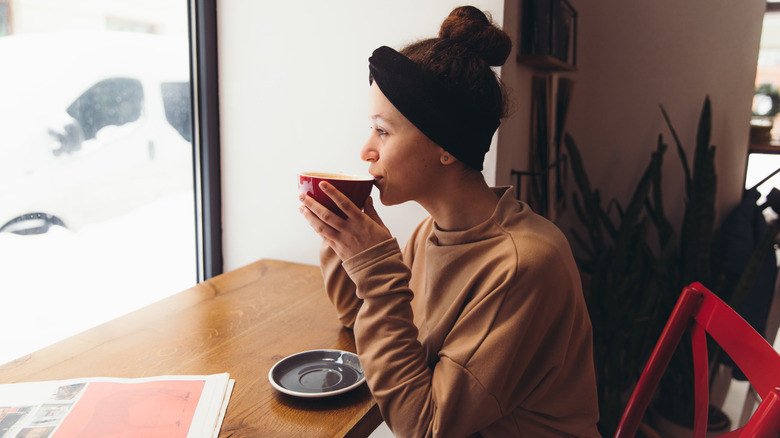 Woman sipping hot coffee