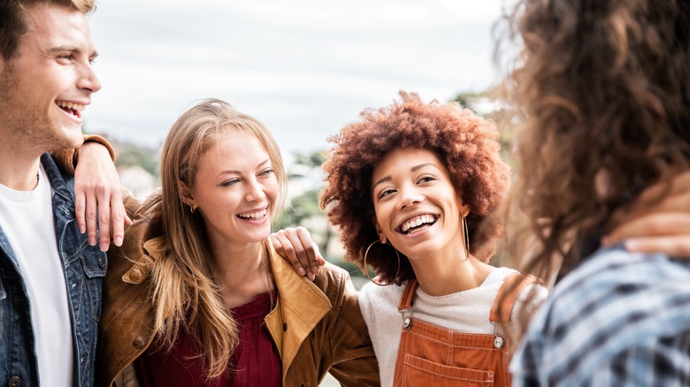 group of friends outside laughing