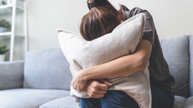 woman clutching to pillow