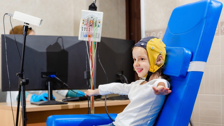 child attached to electroencephalography machine