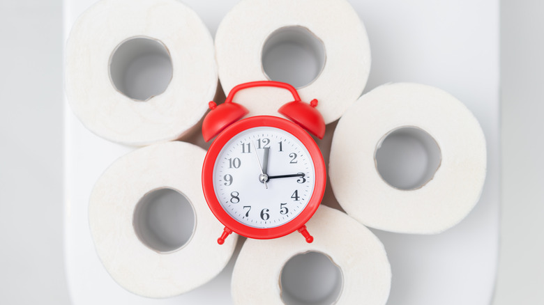 clock surrounded by toilet paper