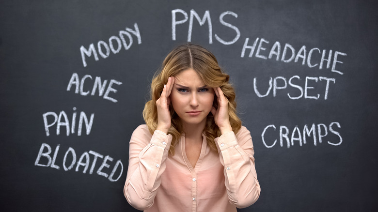 woman surrounded by PMS descriptors