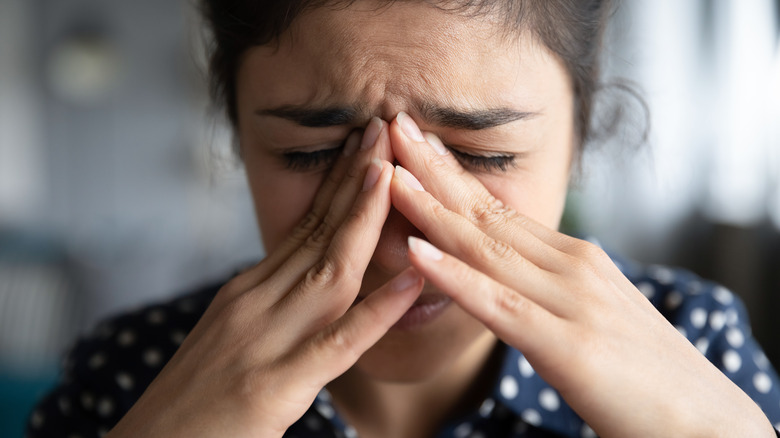 frowning upset woman with hands on face