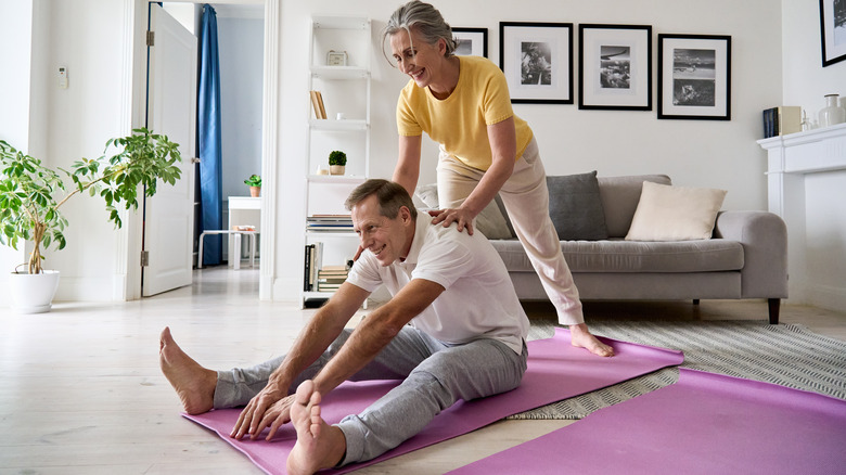 older couple exercising on yoga mats