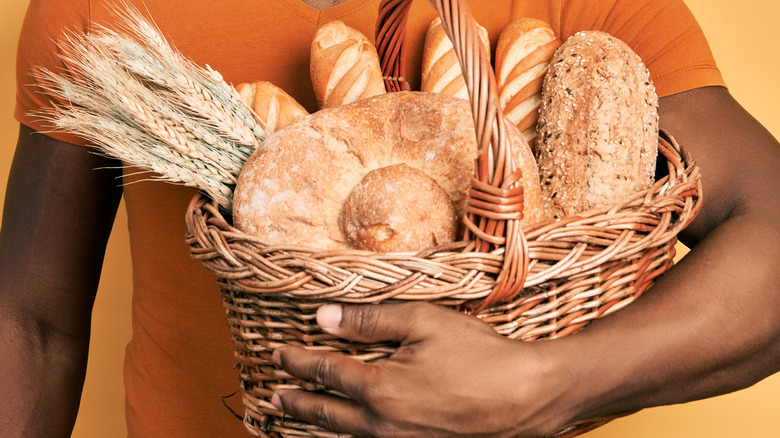 young black man holding basket of bread