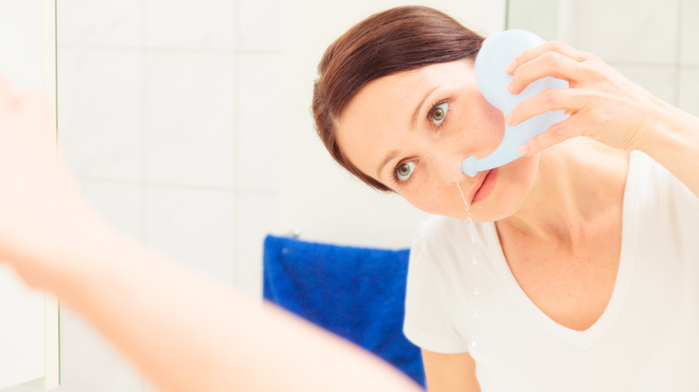 woman using neti pot