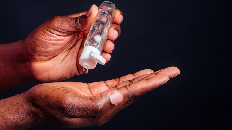 man using hand sanitizer