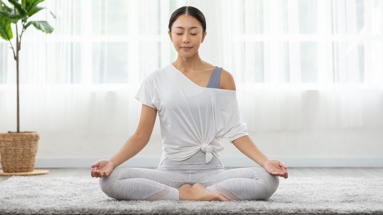 Woman meditating to help stress