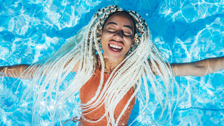 woman with long braids in pool