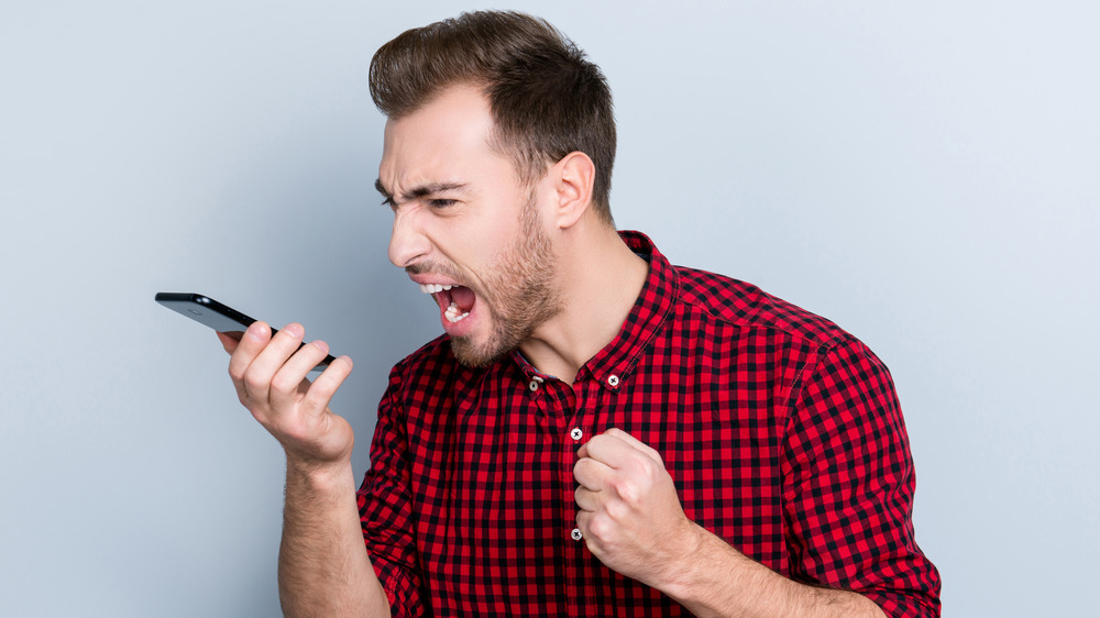 angry man yelling at smartphone