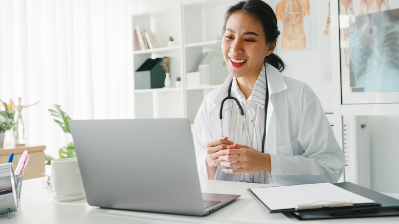Asian doctor on a telehealth appointment with a patient