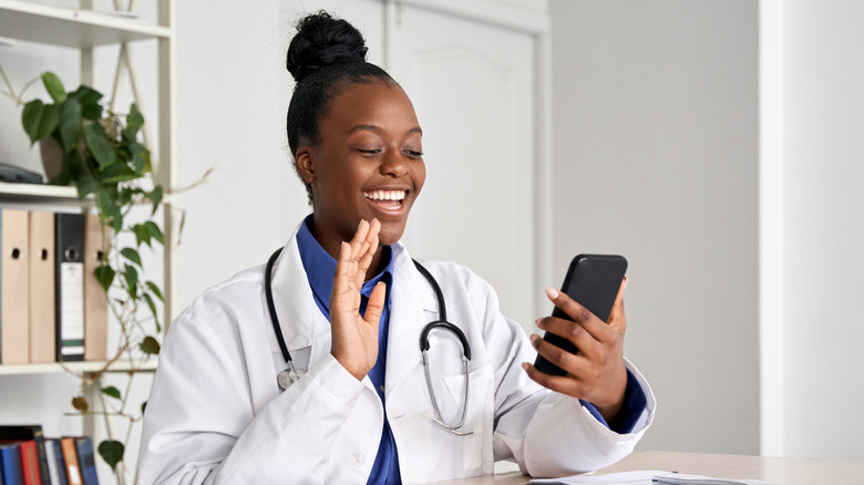 Black doctor doing a telehealth appointment on their cell phone