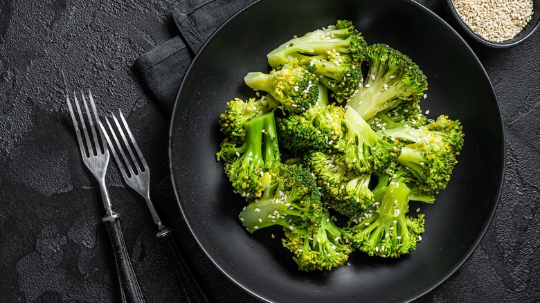 steamed broccoli on black table