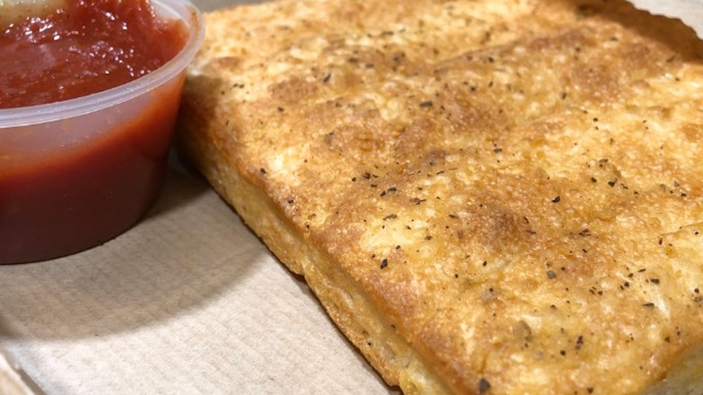 Sheet of breadsticks and dipping sauce