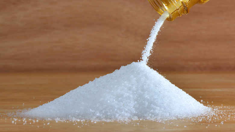 salt pouring out of glass bottle